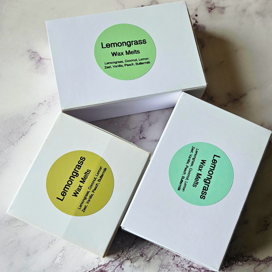 Three boxes of Lemongrass wax melts on a marble surface