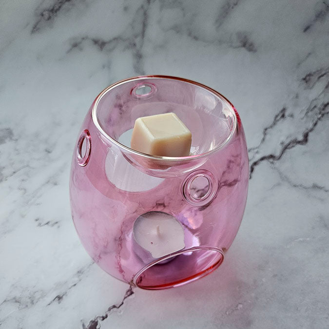 Close up of pink wax melter with wax melt