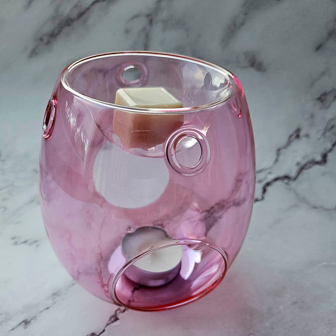 Close up of pink wax melter with wax melt